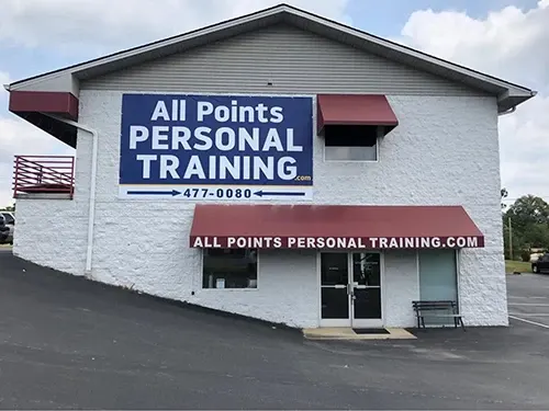 The All Points gym: a white brick building with maroon awnings on Suncrest Street